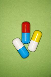 Medical pills on a green background.