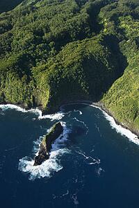 Aerial view of Maui, Hawaii coast with rock jutting out of Pacific ocean