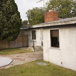 Back view of house with back yard and patio.