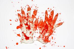Pair of rubber gloves with blood splattered on them.