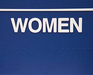 Blue women sign with braille.
