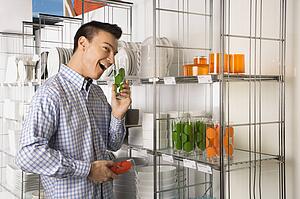 Man shopping for dishes in a store
