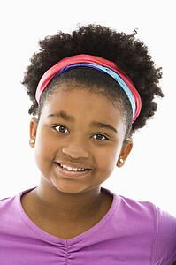 Girl wearing headband smiling at viewer