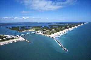 Aerial view of Indian River Lagoon Scenic Highway on Melbourne Beach, Florida with inlet and pier.