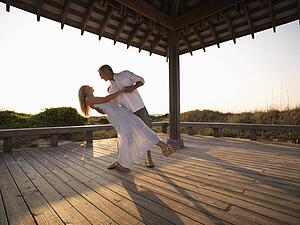 Couple dancing under gazebo at the beach