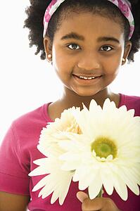 Girl holding large Gerbera Daisies 