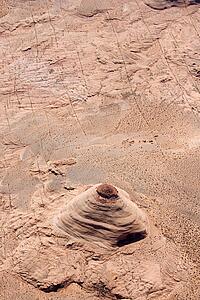 Aerial of extruding rock formation in desert landscape of Utah, USA