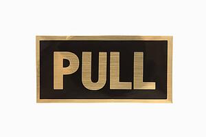 Pull sign with gold text against white background.