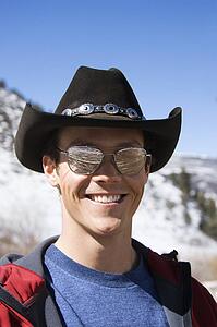 Male wearing sunglasses and cowboy hat