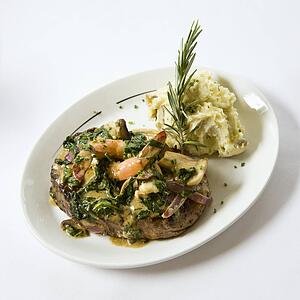 Still life shot of meat entree with mash potatoes.