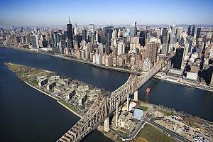 Aerial view of Queensboro Bridge in New York City with Roosevelt Island and Manhattan cityscape