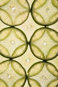Lime slices arranged in design on white background.