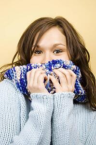 Woman covering mouth with scarf