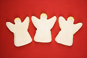 Three angel sugar cookies with decorative icing.