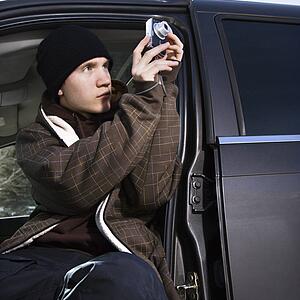 Teenager taking a picture from his car