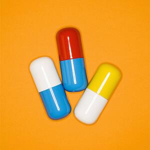 Medical pills on a orange background.