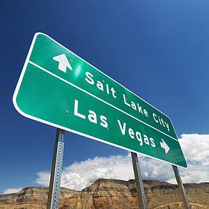 Road sign in desert pointing towards Salt Lake City and Las Vegas