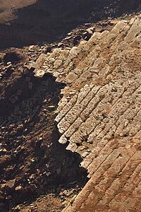 Aerial of deteriorating rock cliff in high desert of Utah