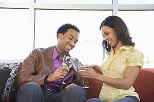 Young couple toasting with wine glasses.