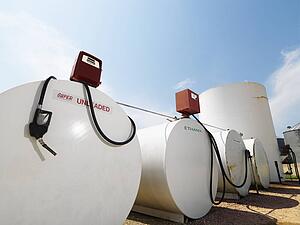 Fuel tanks labeled unleaded and ethanol and pumps