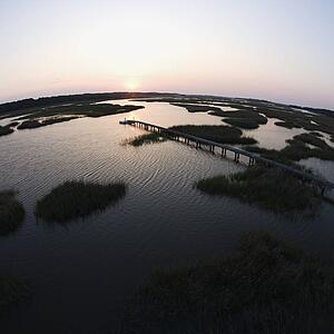 Aerial view of pier in coastal wetland on Bald Head Island, North Carolina.