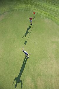 Aerial view of mid adult Caucasian man and woman being excited on golf course at Bald Head Island, North Carolina.