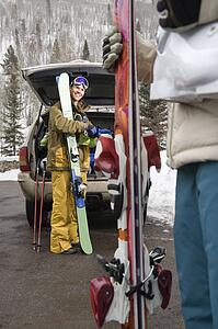 Couple standing with ski equipment 