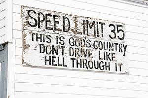 Funny small town speed limit sign