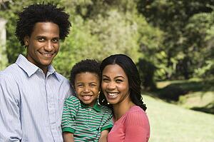 Family portrait of parents and young son smiling