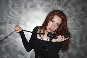 Woman holding telephone receiver to ear