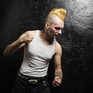 Male punk with clenched fists looking downward