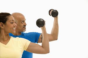 Exercising with dumbbells doing bicep curls