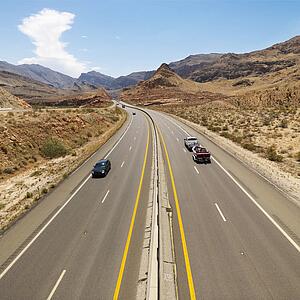 Birds eye view of automobiles on rural desert highway
