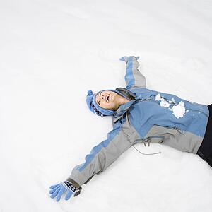 Woman making snow angel
