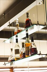 Glass shelves with liquor bottles.