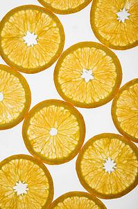 Orange slices arranged in design on white background.