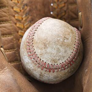 Close up of baseball resting in baseball glove