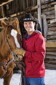 Cowboy petting horse