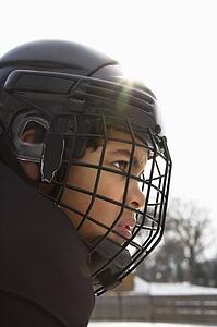 Hockey player boy in helmet