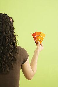 Woman holding paint color swatches