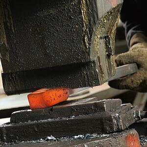 Caucasian man using power hammer.