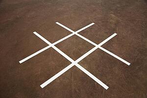 Tic tac toe game on playground concrete.
