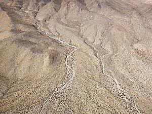 Aerial view of torrid California desert with rocky landforms