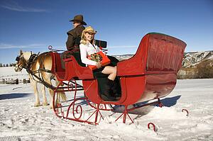 Holding present in horse-drawn sleigh