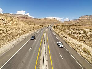 Birds eye view of automobiles on rural desert highway