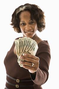 Woman holding twenty dollar bills in hand
