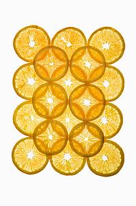 Orange slices arranged in design on white background.