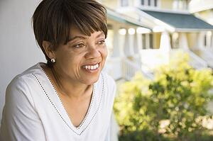 Woman outside home smiling