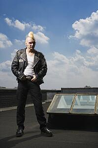 Portrait of mid-adult punk standing on roof