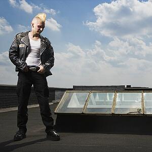 Male punk standing on roof